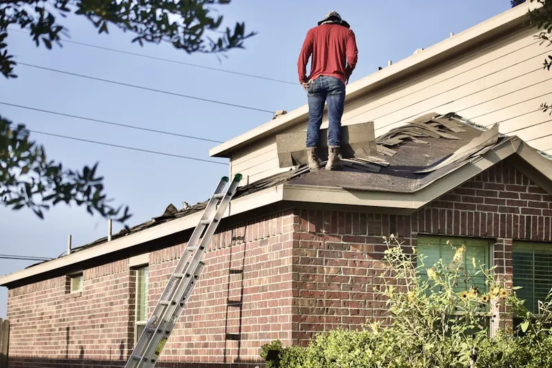 Professional roofer working on a residential roof in Skylands